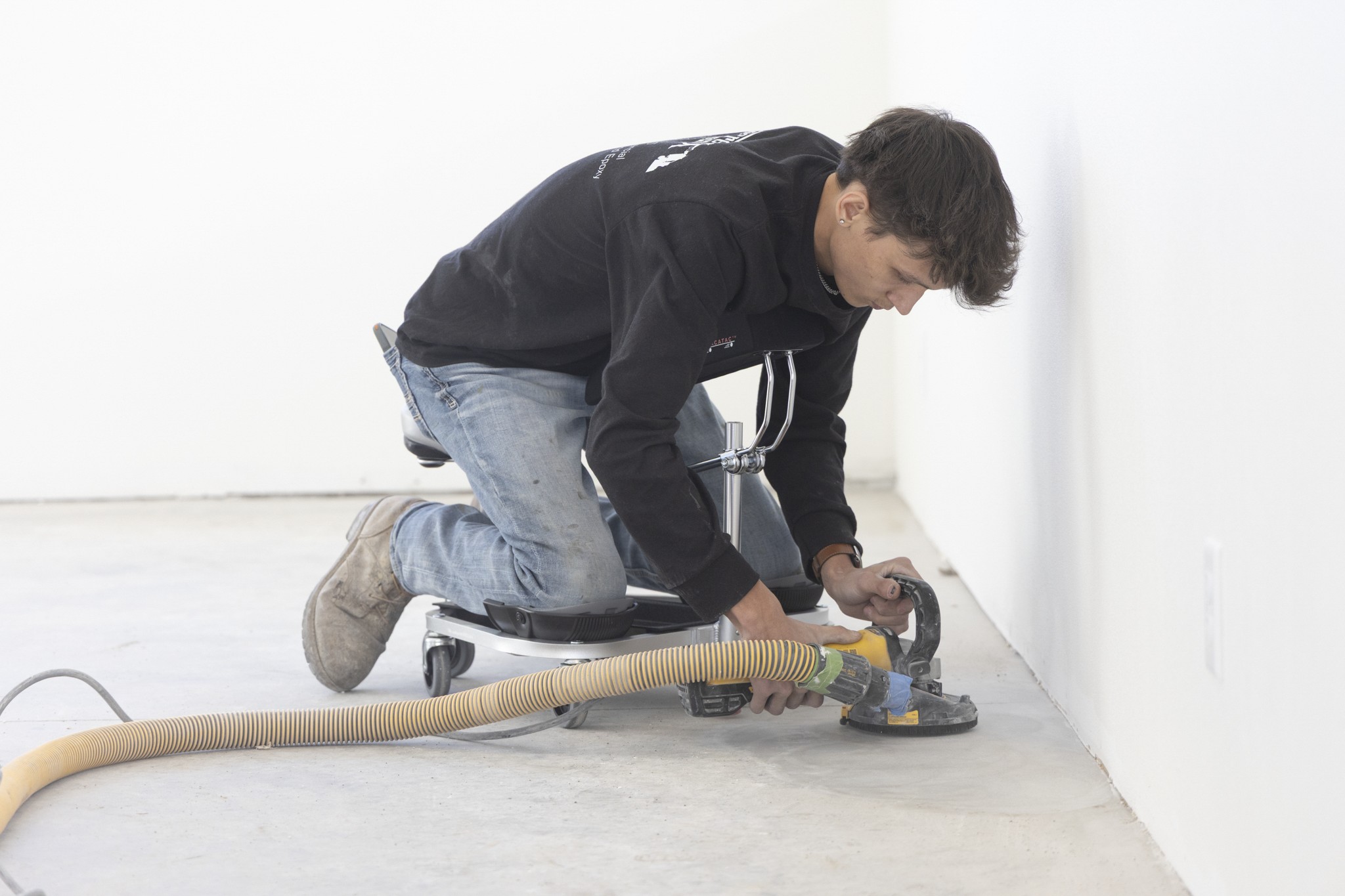 man using RACATAC with chest support to polish concrete floors